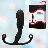 An Aneros Helix Syn Trident Prostate Stimulator by Aneros is showcased with packaging labeled "HELIX SYN Trident Series" against a gentle, vibrant background. This hands-free male G-spot massager boasts a curved design highlighted by a bold red accent on one end.